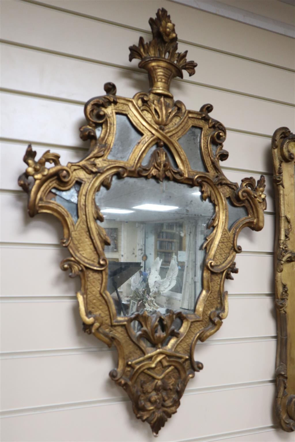 A pair of Italian rococo style carved giltwood wall mirrors, width 56cm, height 88cm